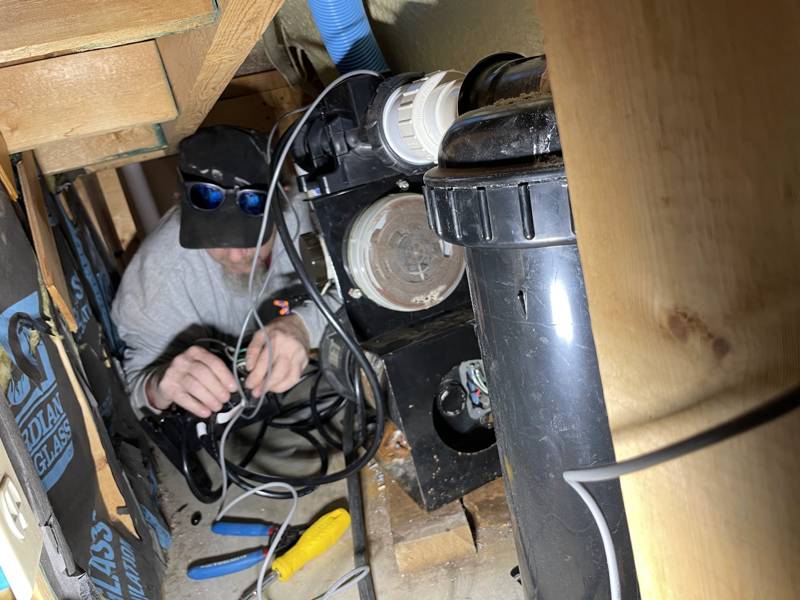 Mirage Spa technician repairing hot tub pump and heater wiring inside the equipment bay